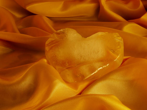 Ice heart on beautiful folded cloth stock photo