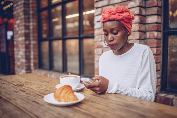 istock Cute woman texting in the cafe 872542886
