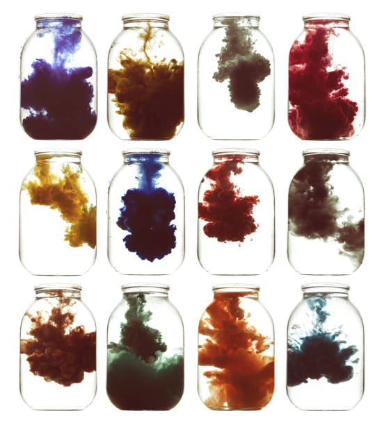 istock Luminous paint swirling in water. 872542902