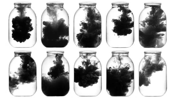 istock Luminous paint swirling in water. 872542996