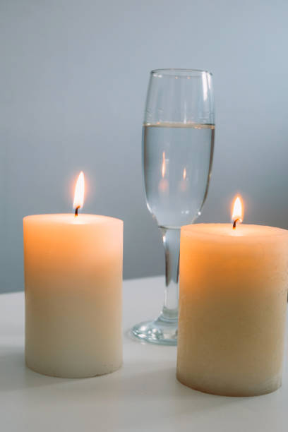 istock glass of white wine and candle 872543228