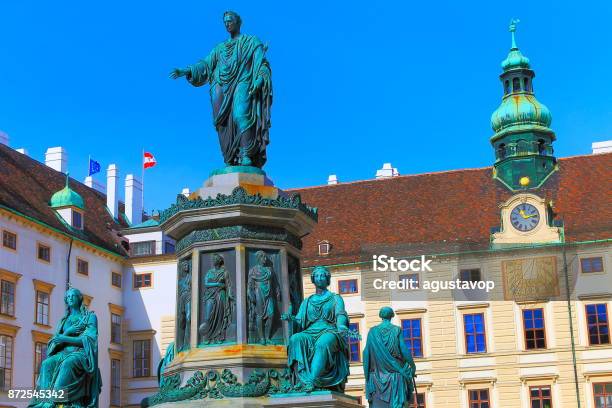 Beautiful Monument To Franz Joseph I Of Austria On Amalienburg Vienna Cityscape Panorama With Impressive Rococo And Reinassance Building Architecture And Urban Skyline At Clear Sky Austrian And Euro Flags Vienna Austria Stock Photo - Download Image Now