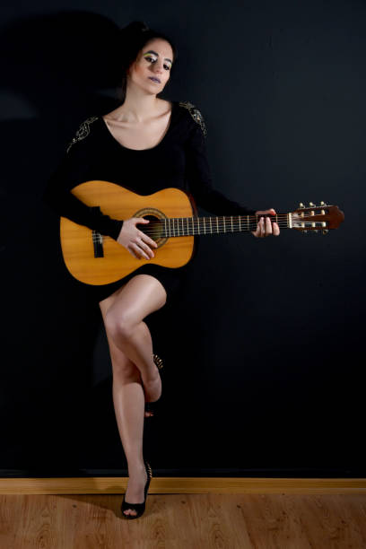 istock young beautiful women with guitar 872546254
