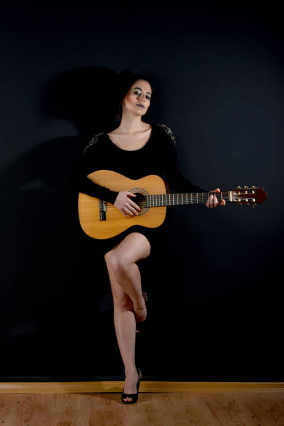 istock young beautiful women with guitar 872546262