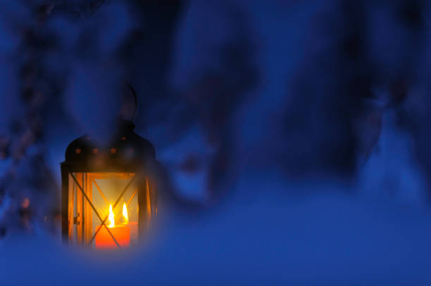 istock Candle lantern in the snow 872546312