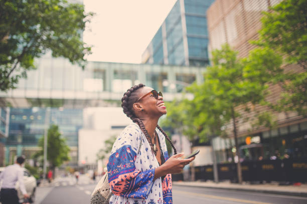 istock Smiling woman texting on the street 872548898