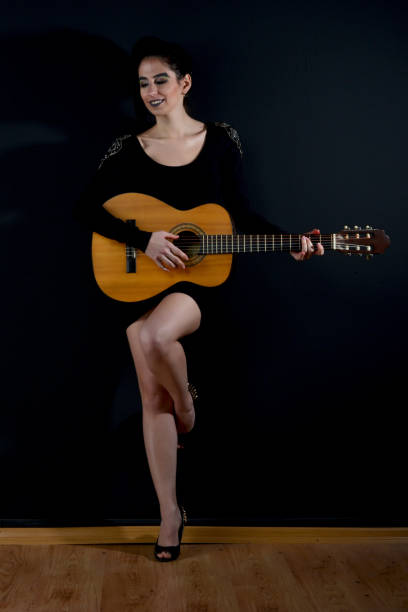 istock young beautiful women with guitar 872548948