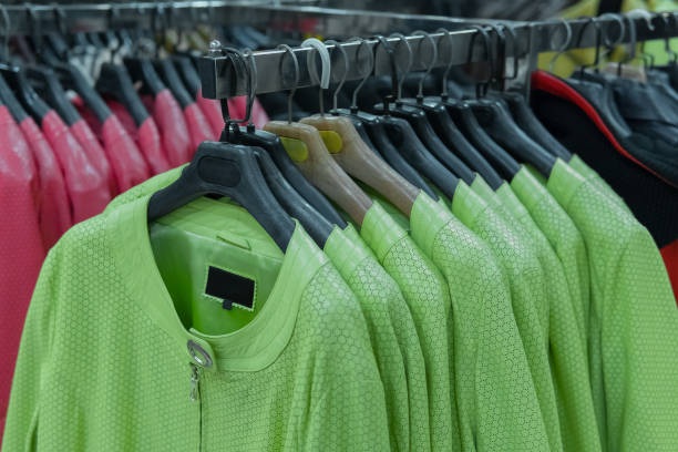 istock Rows of green and red leather jackets on the racks 872553406