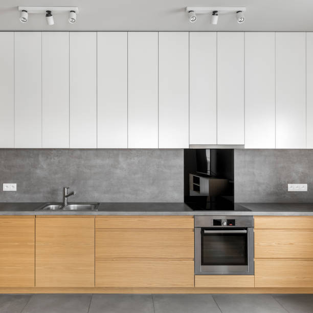 istock Grey kitchen with wooden cabinets 872553906