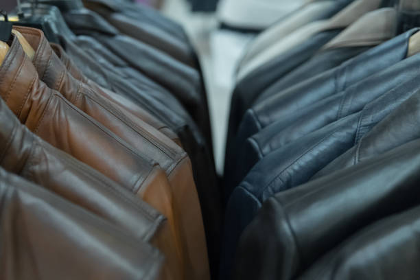 istock Black and brown leather jackets on rack, closeup 872553914