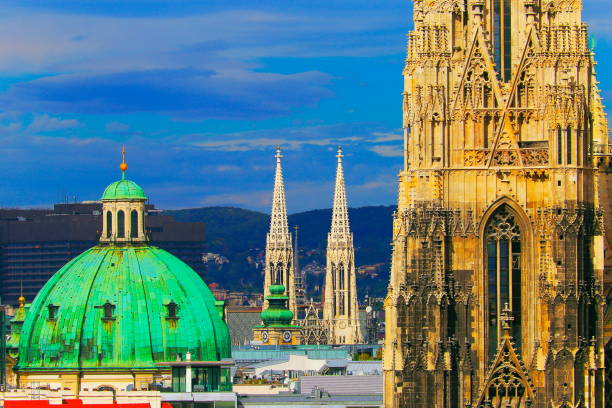 Above Beautiful Vienna Cityscape panorama, with St. Stephen's Cathedral, Votivkirche and st. Peter church - impressive building architecture and urban skyline at dramatic dawn – Vienna , Austria