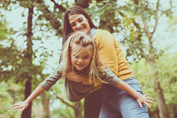 istock Mother carrying child like she is flying. On the move. 872554742