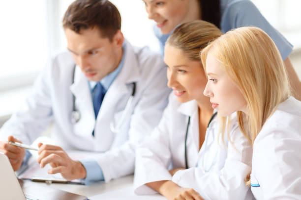 istock group of doctors looking at laptop computer 872557512