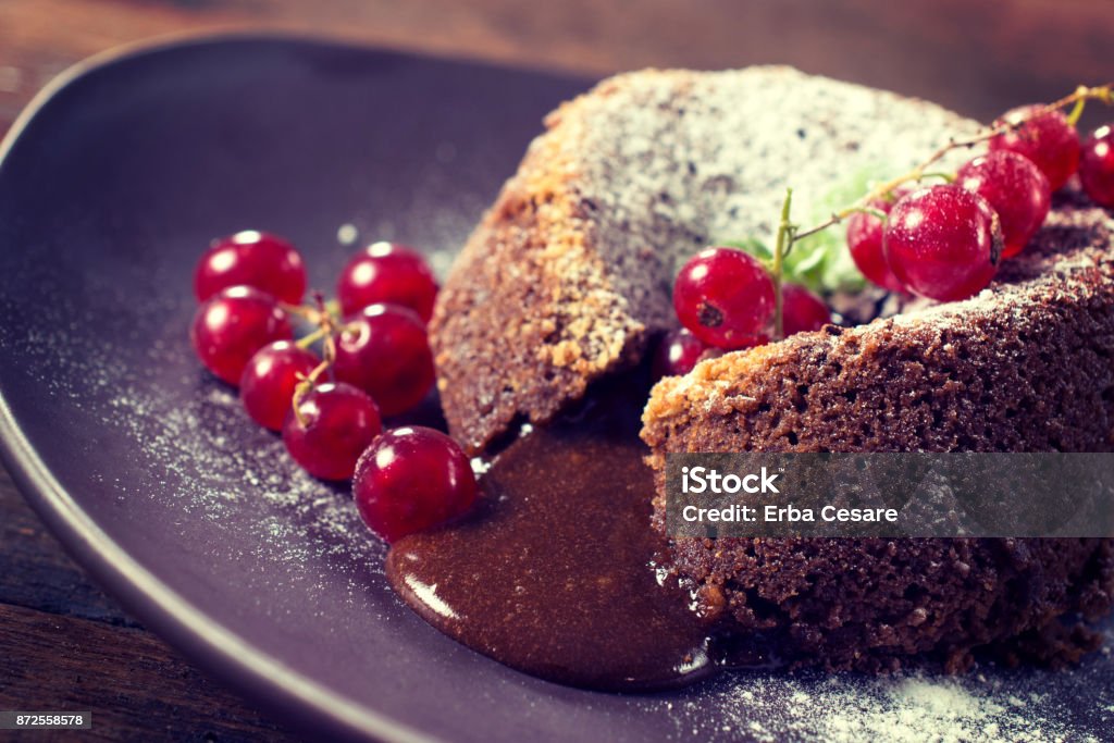 Sweet meal Red currants and lava cake stuffed with melted chocolate,selective focus Molten Chocolate Cake Stock Photo