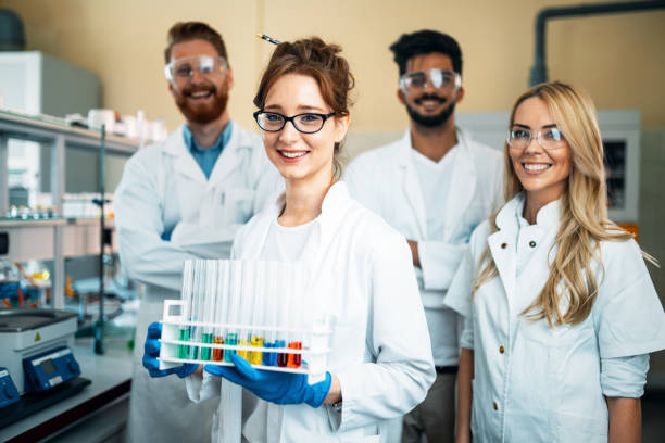 istock Group of young successful scientists posing for camera 872558600