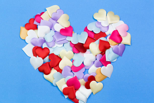 istock Decorative colourful sponge is small heart blue background. 872561964