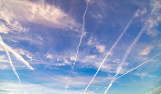 istock traces of an airplane at sunset as background 872566248