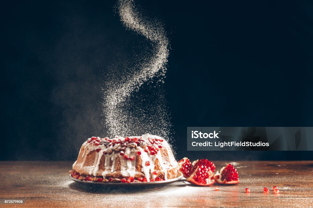 christmas cake powdering with icing sugar traditional homemade christmas cake with pomegranate powdering with icing sugar Christmas Stock Photo