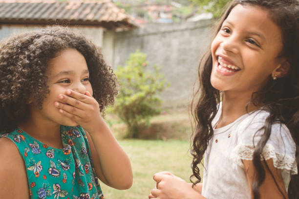 istock Two girls laughing 872572120