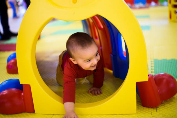 istock Baby boy playing in a tunnel tube 872572396