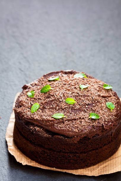 istock Belgian  chocolate fudge cake on black stone background 872572530