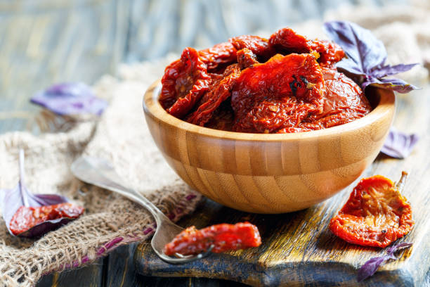 istock Sun-dried tomatoes and purple Basil in a round bowl. 872573130