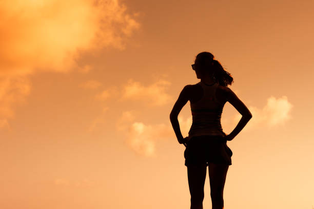 istock Woman watching beautiful sunset 872576168