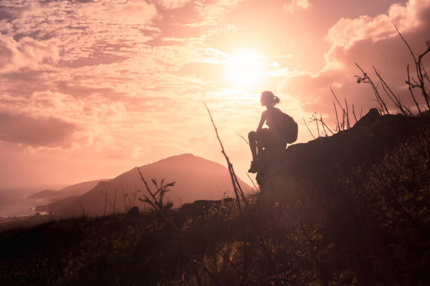 Woman enjoys the view at mountain peak