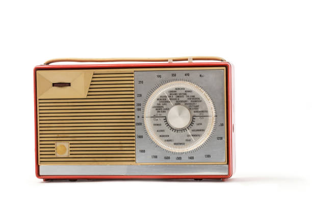 A vintage radio on a table with nature as a backdrop.