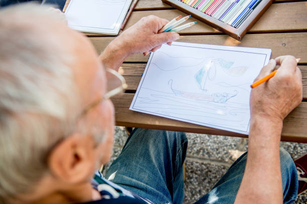 Senior Man Coloring a Coloring Sketch