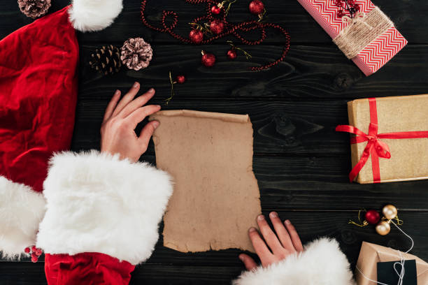 istock Santa claus with presents list 872593660