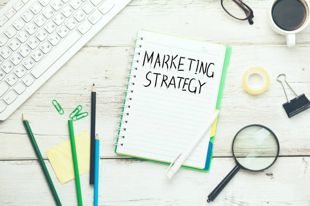 istock marketing strategy with keyboard and stationary on table 872593998