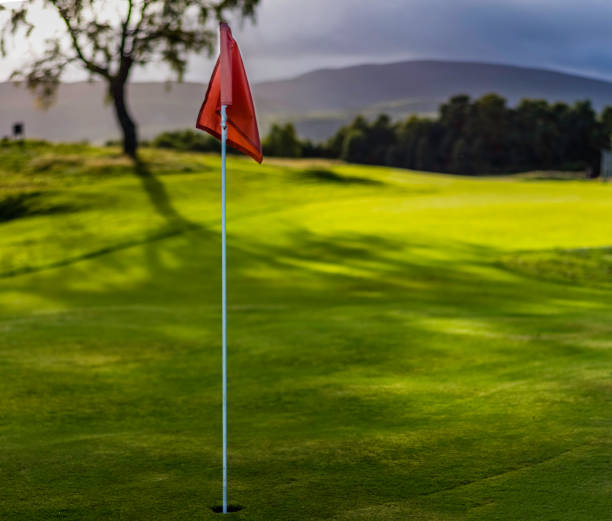 Golf flag on Spey Valley championship golf course in Aviemore at Dalfabour Village Club. Golf flag cairngorm mountains stock pictures, royalty-free photos & images