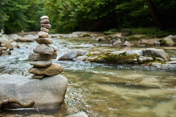 Stones arranged in zen towers by the river bed