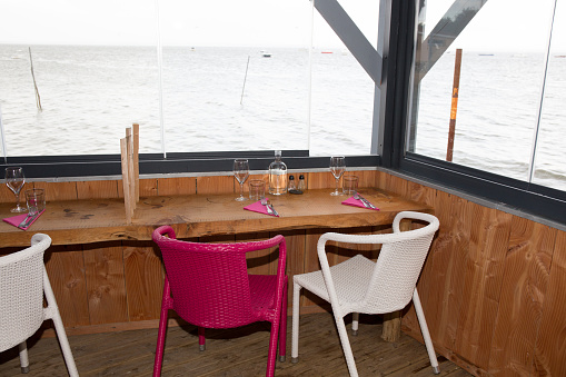 Modern restaurant interior with scenic seaside view