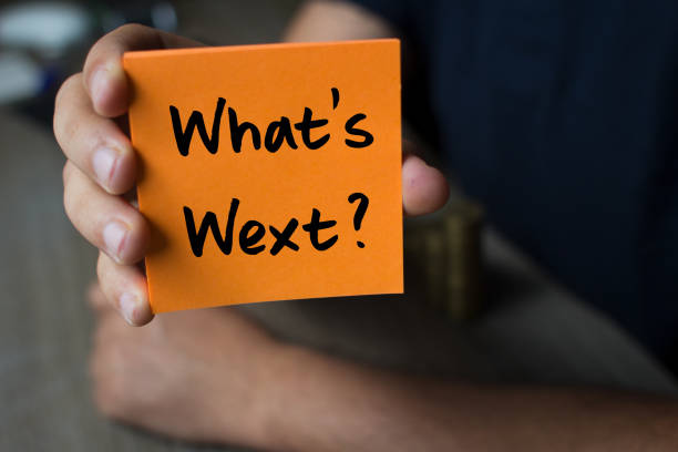 istock What's Next?, on an orange note paper - Business Concept 872602292