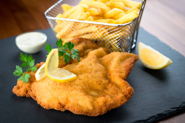 istock Wiener schnitzel with fried potatoes 872605032