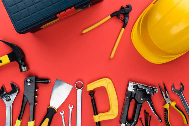 reparement tools and hard hat Top view shot of different reparement tools, toolbox and hard hat, isolated on red c clamp photos stock pictures, royalty-free photos & images