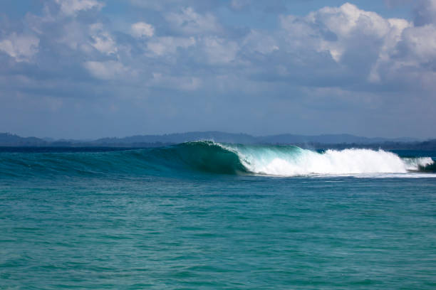 Mentawai Islands Breaking wave goes unridden in tropical indonesia A wave goes unridden at "Pitstops" surf break in the Mentawai Islands off Sumatra's West Coast. There are many surf breaks in this area that people travel from around the world to stay in surf camps or onboard boats. Mentawai Islands stock pictures, royalty-free photos & images