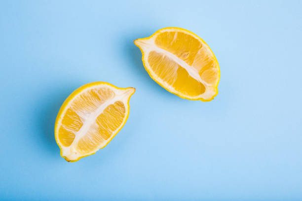 istock Two halves of lemon on a blue background 872611842