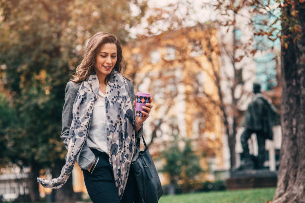 istock Woman drinking coffee in the city 872611930