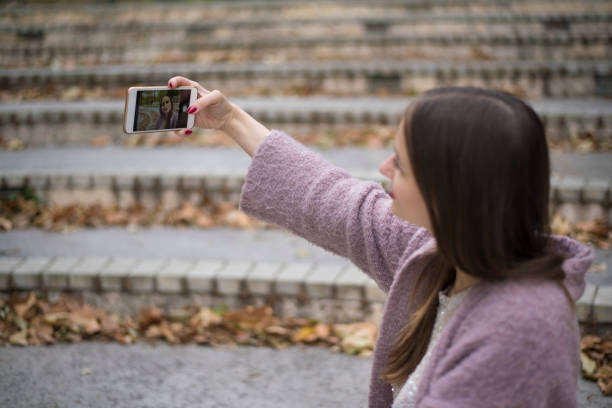 istock Beautiful woman taking selfies at the park 872618930