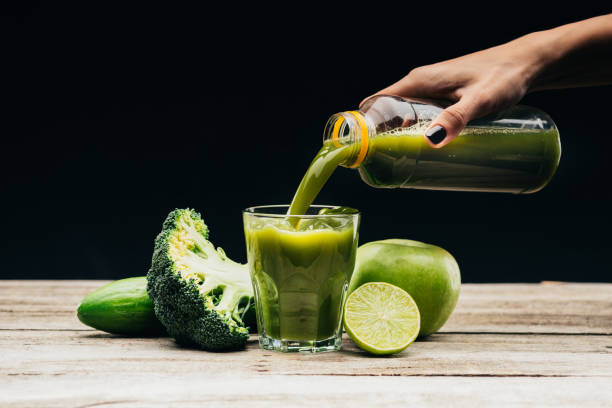 istock woman pouring fresh juice into glass 872619108