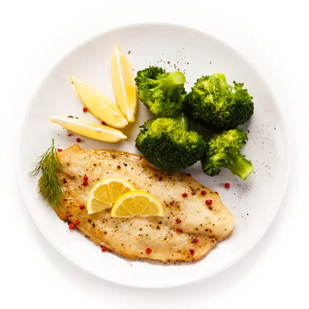 Fish dish - fish fillet and vegetables on white background