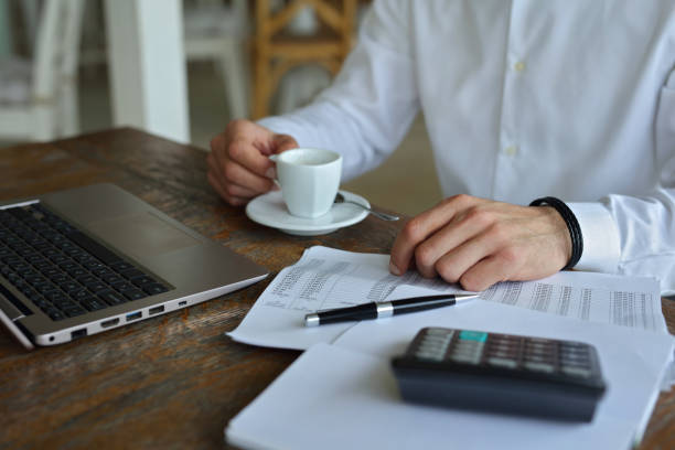 istock Business concept. Businessman using laptop computer in cafe close up 872624778