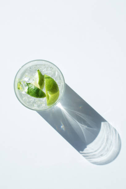 Gin Tonic cocktail in glass top view of Gin Tonic cocktail in glass with shadow on white gin tonic stock pictures, royalty-free photos & images