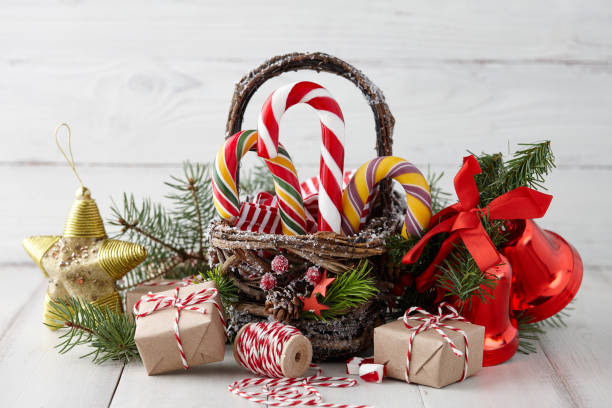 istock Christmas basket with candy canes on white planks 872625422