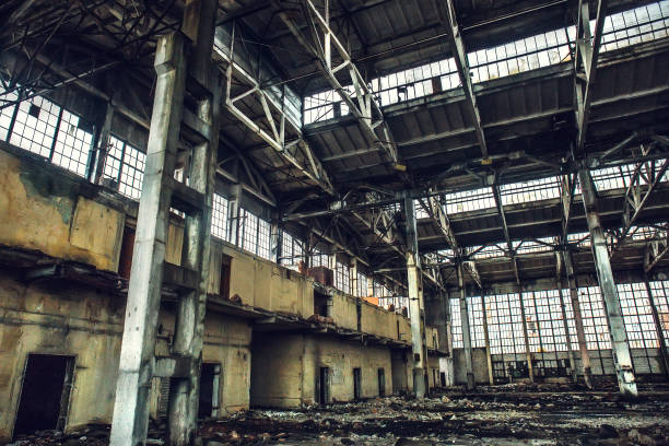 istock Abandoned large industrial hall or warehouse with garbage, ruined factory 872625728