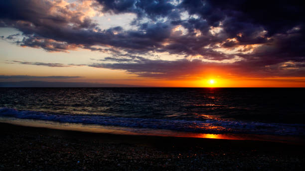 istock Dramatic red cloudscape sunset on the Beach, Montrouis, Haiti 872628428