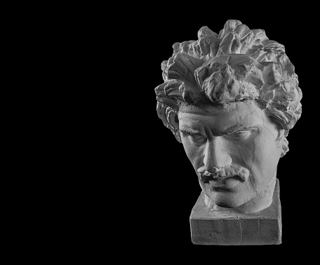 White plaster bust sculpture portrait of a young man with a mustache